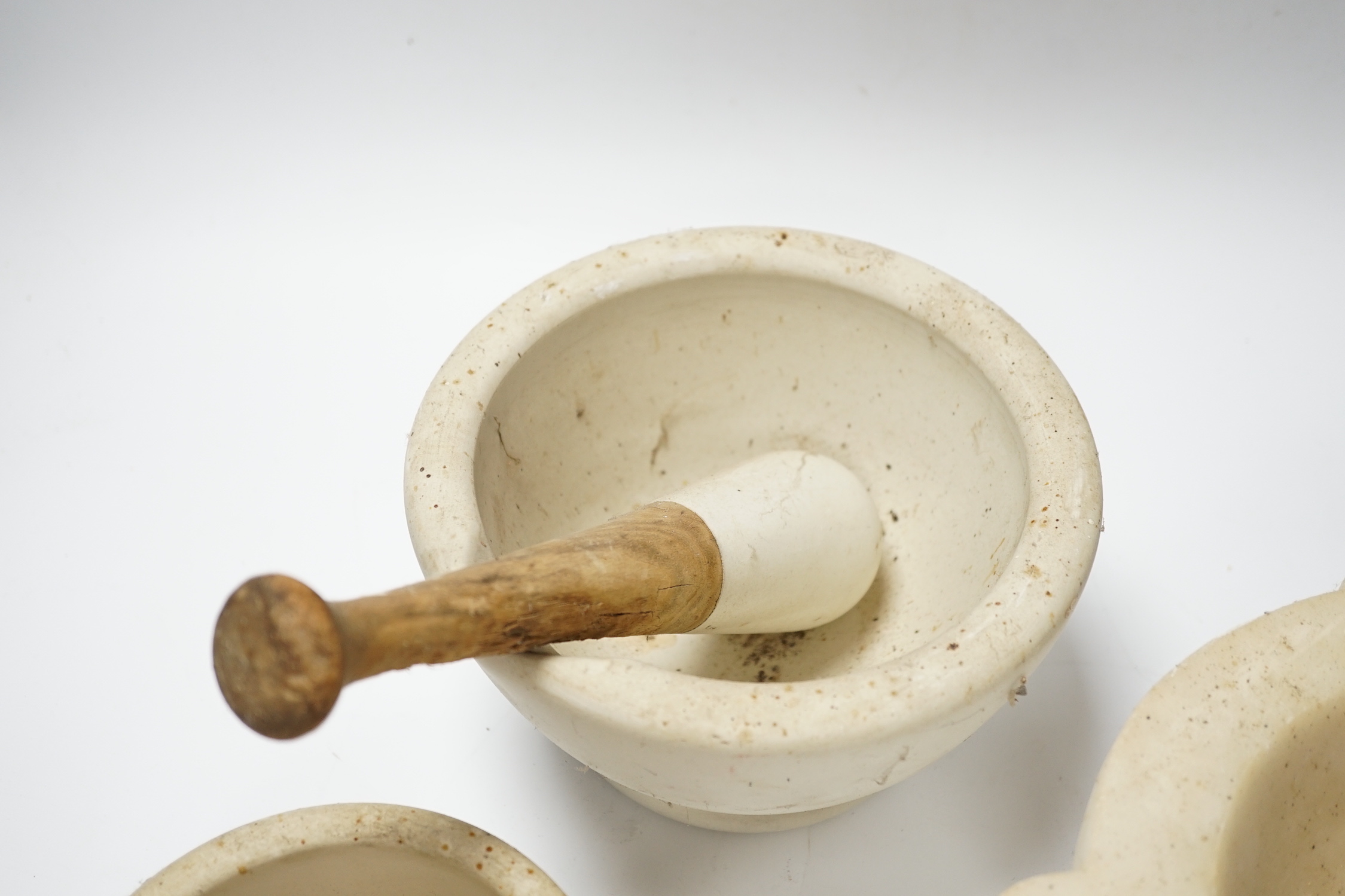 Four mortars and three pestles, largest 23cm wide